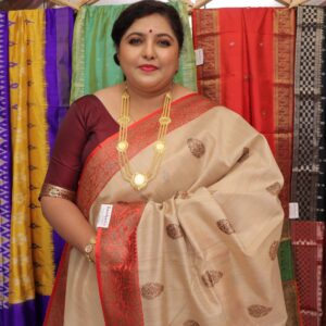 Beige Tussar Banarasi saree with red and gold woven floral border and traditional buti motifs