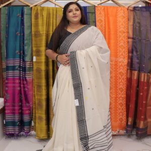 Off-white Dhanekhali handloom cotton saree with black striped border and traditional woven design